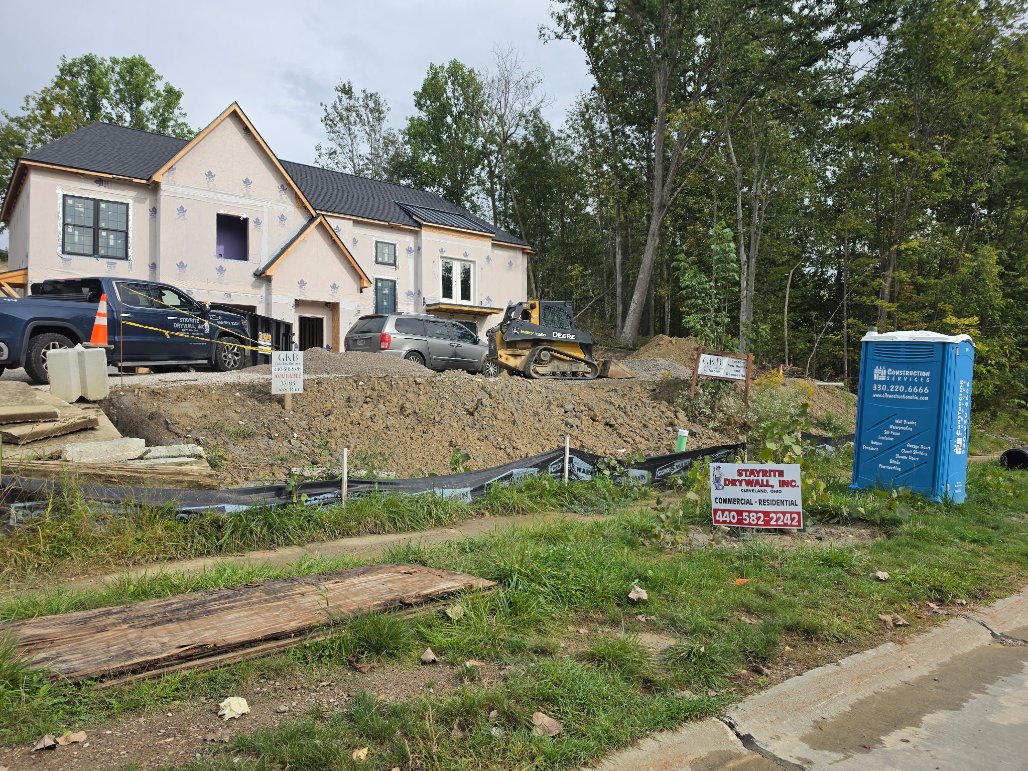 Stayrite Drywall truck and job sign at an active residential construction site